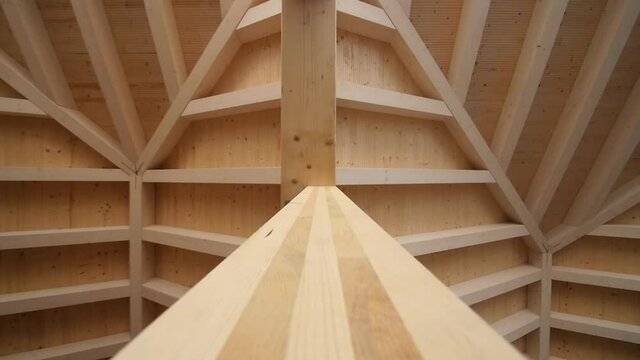 Beautiful wood symmetry in a wooden roof structure in modern construction site under architecture development