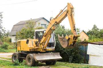 Excavation work in the industrial zone. Bulldozer on site in the village zone