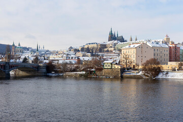 Obraz premium Snowy Prague Lesser Town with Prague Castle above River Vltava in the sunny Day , Czech republic