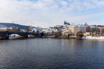 Plakat Snowy Prague Lesser Town with Prague Castle above River Vltava in the sunny Day , Czech republic
