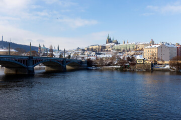 Snowy Prague Lesser Town with Prague Castle above River Vltava in the sunny Day , Czech republic