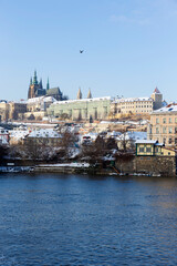 Obraz premium Snowy Prague Lesser Town with Prague Castle above River Vltava in the sunny Day , Czech republic