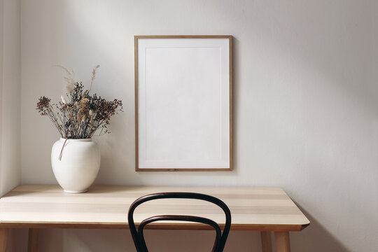 Living Room, Indoor Still Life. Empty Picture Frame Mockup On Wooden Desk, Table And Old Chair. White Vase With Dry Grass. Elegant Working Space, Home Office Concept. Scandinavian Interior Design.