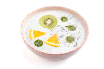 Yogurt with kiwi, gooseberry, chia in ceramic bowl isolated on white background. Side view.