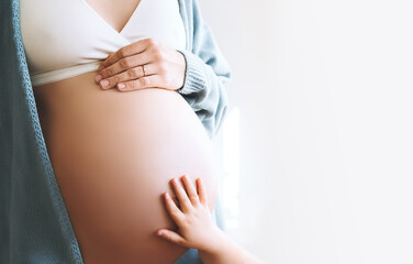 Concept of Family, Pregnancy, Motherhood, New Life. Close-up beautiful pregnant woman belly with...