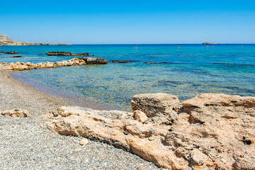Fototapeta na wymiar Beautiful rocky beach on the shore of Mediterranean Sea