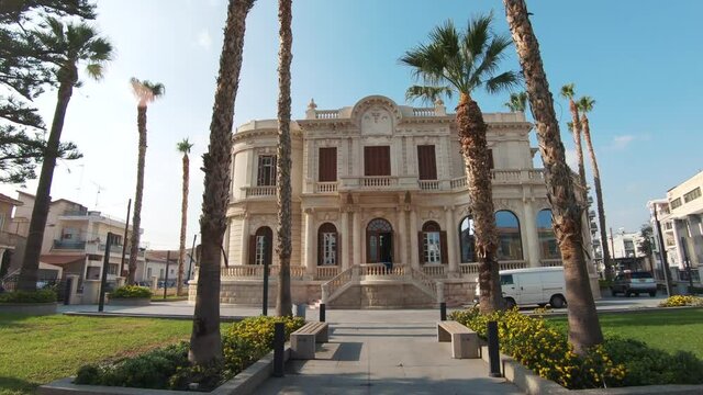 Establishing view of Limassol Municipal University Library on a clear summer day, Cyprus - Wide push in Gimbal shot