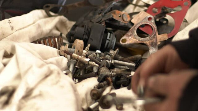 The Craftsman Serviceman Car  In The Repair Shop Lets The Suitable Screws While Gathering