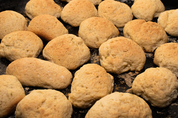 several rolls of homemade bread on a black mold