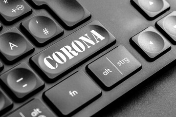 graue Corona Taste auf einer dunklen Tastatur