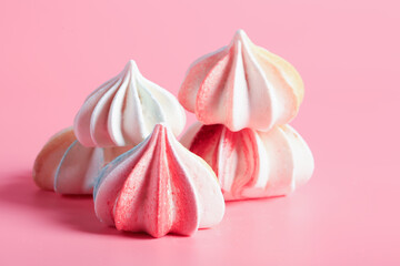 Meringue candy on pink background