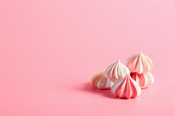 Meringue candy on pink background
