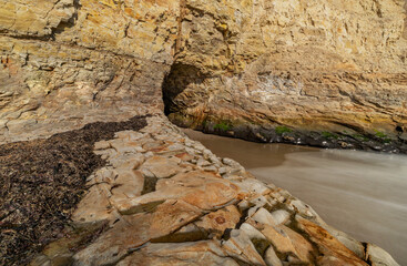 A small cave in the bay of shark fin, beautiful beach landscape on the coast of the California Highway, ocean, rocks, great sky, clear sunny weather.