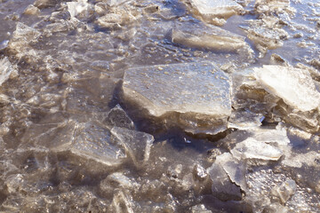chunks of ice have grown in places into a frozen puddle