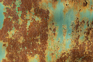 the blue iron wall rusted and in places the paint peeled off, exposing the yellow