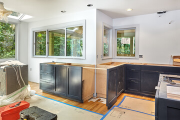 Kitchen cabinet installation continues, with island complete, ready for countertop template