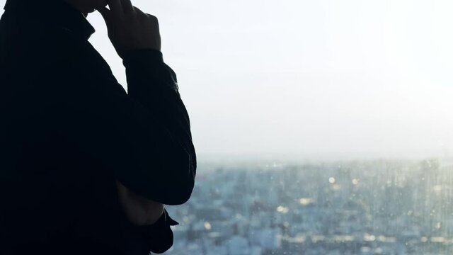 窓辺で悩む男性　シルエット　スローモーション