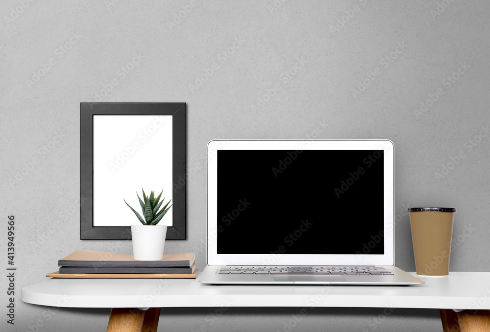 Wall mural mockup template laptop computer display screen and picture frame with blank on desk, workplace and o