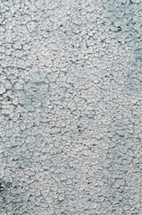 Old faded background, cracked white paint on the wall, surface with cracks