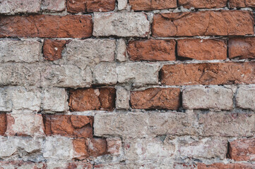 Background old surface, vintage wall with red bricks with peeling plaster, grungy texture.