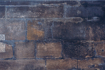 Vintage background masonry, old dirty wall ancient building, smooth textured surface blackened with age and weathering.