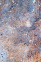 Very old textured surface, ancient stone exposed to atmosphere and water outdoors, vintage background close-up