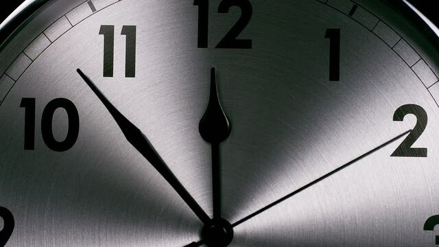 Camera zooms into a clock face as the hands whizz around towards 12 o'clock