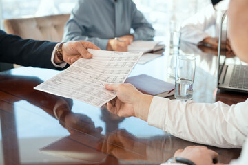 Hand of mature male delegate taking document with financial data held by partner