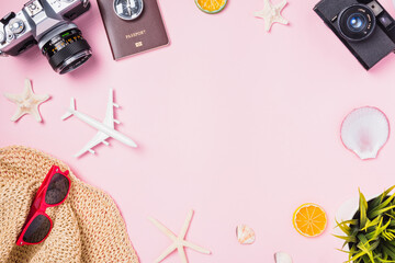 Top view flat lay mockup of retro camera films, airplane, starfish, hat and traveler tropical accessories isolated on pink background with copy space, Business trip, and vacation summer travel concept