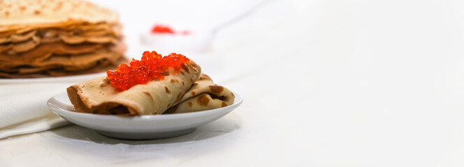 thin pancakes with red caviar on white napkin. The concept of the Russian carnival Maslenitsa. space for text, banner