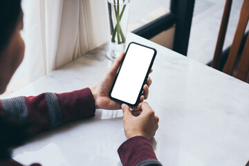 cell phone blank white screen mockup.woman hand holding texting using mobile on desk at office.background empty space for advertise.work people contact marketing business,technology