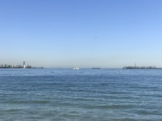 White ship on the horizon in the harbor