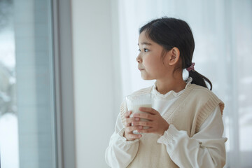 Closeup of little girl drinking milk