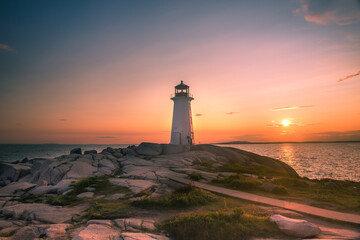A dramatic sunset at Peggy's Cove Lighthouse Atlantic Coast Nova Scotia Canada. The most visited tourist location in the Atlantic Canada and famous Lighthouse captured with vibrant colors during sunse © Prashanth Bala