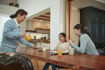 happy young female people eating croissant and drinking coffee and juice