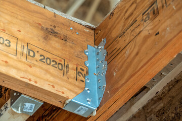 Close up of galvanized metal connector plates, rafter for wood, trusses, holding up beams for a new residential construction site