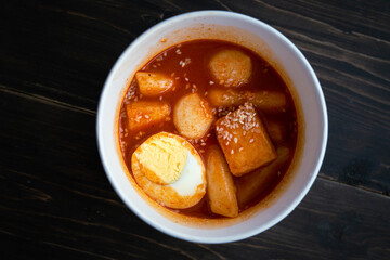 Stir-fried Rice Cake Tteok-bokki in a takeaway container. Korean food delivery.