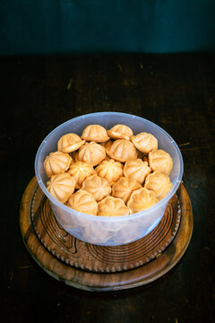 Kuih Bahulu, baulu or bolu in a container. Sponge cake baked in special aluminium moulds is the Asian tradition food in popular Malaysia and Indonesia.