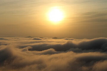 Sun at sunset over the clouds