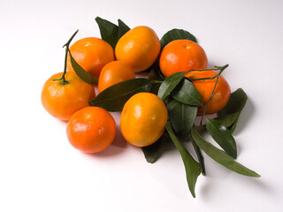 Tangerines with leaves on a white background. Chinese sweet tangerines