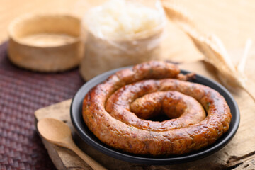 Northern Thai sausage (Sai Aua), Grilled intestine stuffed with minced pork, spices and herbs eating with sticky rice, popular food in Chiangmai, Thailand