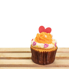 Lovely cupcake, a close up of homemade butter cream cake bakery  with red heart shape topping isolated with wooden tray on white background.