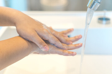 Prevent coronavirus or COVID-19 concept. Handwashing of hand and wrist wash with bubble soap at sink.