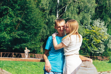 Naklejka premium A young couple of lovers hugging by the lake