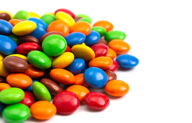 Pile of Rainbow Colored Candy Coated Chocolate Buttons Isolated on a White Background
