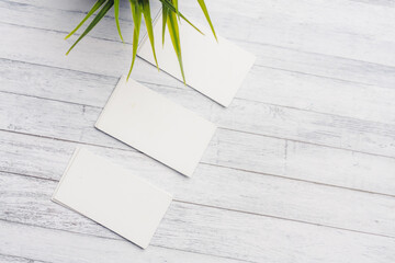 white business cards on a wooden background letterhead top view