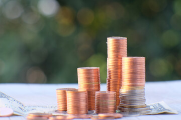 stack of coin on table background and business or finance saving money