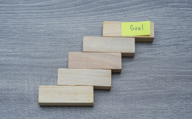 success in people lift concept - step by step to achieve the goals with wood background