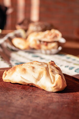 Arabic empanadas on wooden plate with natural light