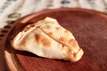 Arabic empanadas on wooden plate with natural light